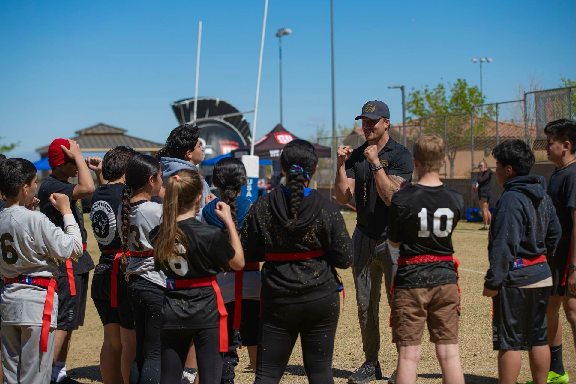 Small group of athletes training tackle technique together